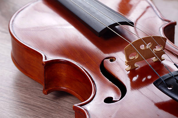 cello front close up, classical music background, classic string instrument, violin texture wooden backgrounds, musical instrument on a dark black background