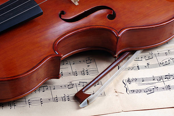 istock beautiful antique violin and notes 2221321160