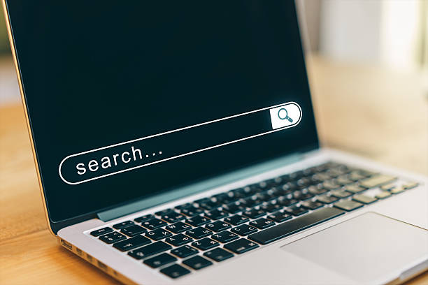 istock Closeup of laptop with digital search bar on screen in bright office setting, symbolizing online browsing and modern internet technology. 2221324929