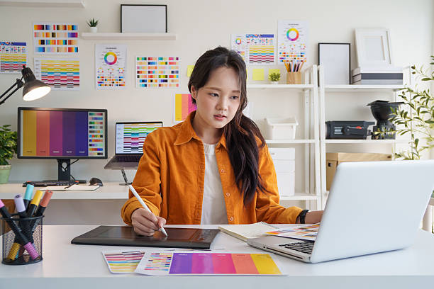istock Creative young woman concentrating on design projects at her workspace. 2221325559