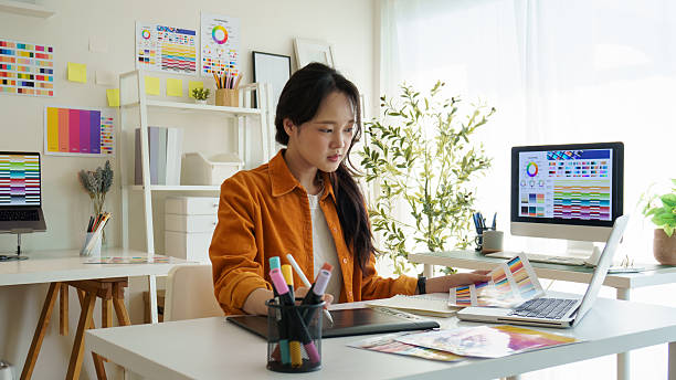 istock Young female graphic designer working on digital artwork at a creative workspace. 2221325578