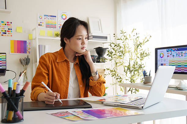 istock Creative young woman concentrating on design projects at her workspace. 2221325582