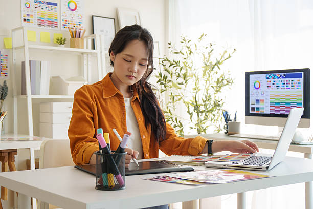 istock Creative young woman concentrating on design projects at her workspace. 2221325583