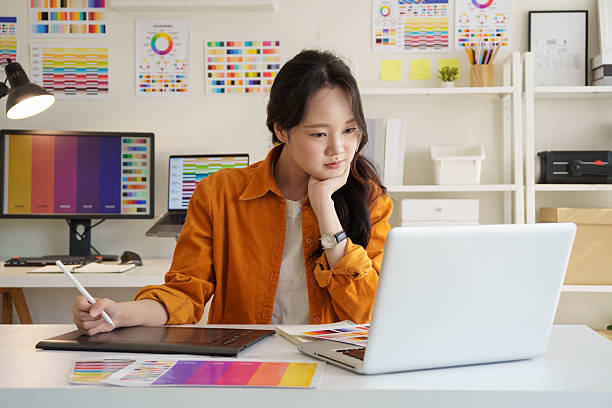 istock Creative young woman concentrating on design projects at her workspace. 2221325617