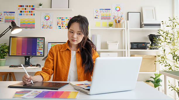 istock Young female graphic designer working on digital artwork at a creative workspace. 2221325620