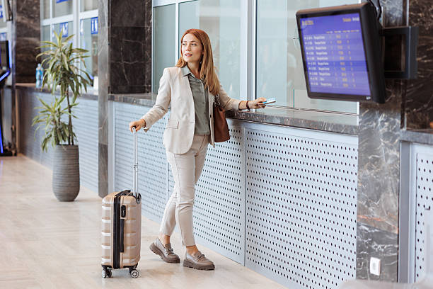 istock Businesswoman checking train schedule and buying a ticket 2221326732
