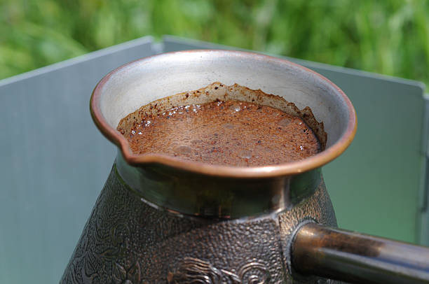 istock Coffee in a turkish pot on a background of green grass 2221326839