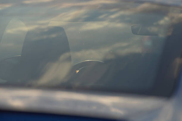 istock A car windshield with a cloudy sky in the background 2221329295