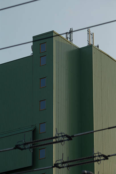 istock A tall green building adorned with numerous wires on its exterior 2221331701