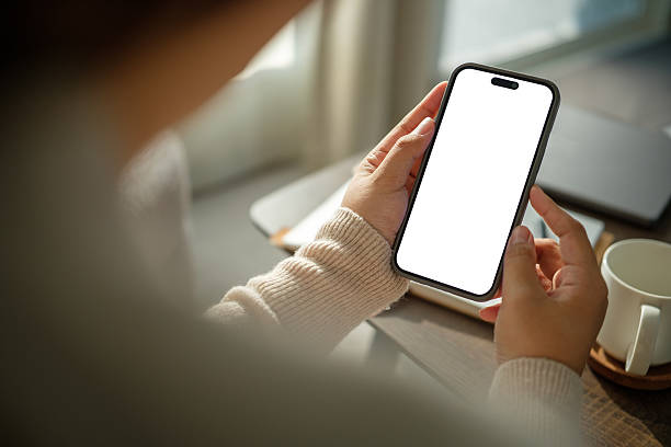istock Female hand using mobile phone with empty screen, for showcasing mobile apps or advertising layouts. 2221334700
