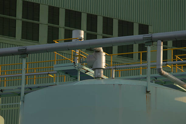 There is a large building prominently featuring numerous pipes protruding from its structure, showcasing its industrial design and function