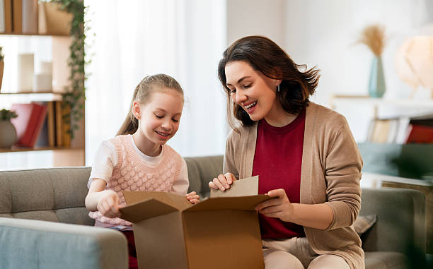 istock Mother and daughter are unpacking cardboard 2221338616