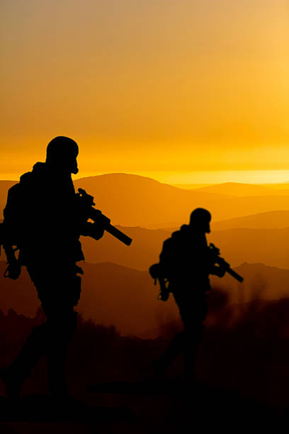 istock Conceptual image of war with sunset and soldier silhouette 2221340068