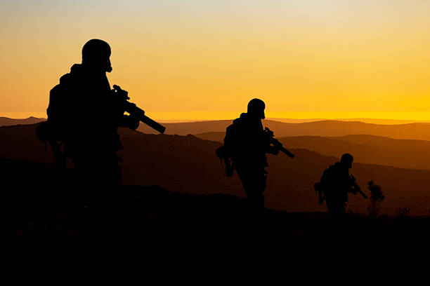 istock Conceptual image of war with sunset and soldier silhouette 2221340082