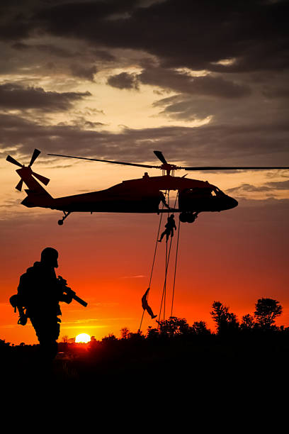 istock Conceptual image of war with sunset and soldier silhouette 2221340100