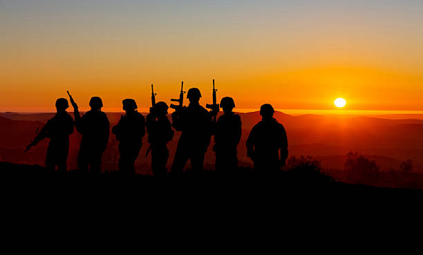 istock Conceptual image of war with sunset and soldier silhouette 2221340104