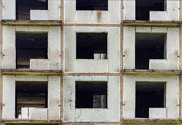 istock A damaged abandoned panel house with decorative facade of small white tiles. 2221341195