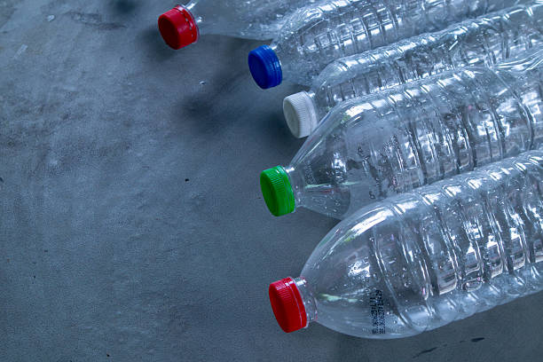 istock Crushed PET Plastic Bottles with Colorful Caps for Recycling. Plastic Waste Pollution and Environmental Concept. High Resolution Close-up. 2221346024