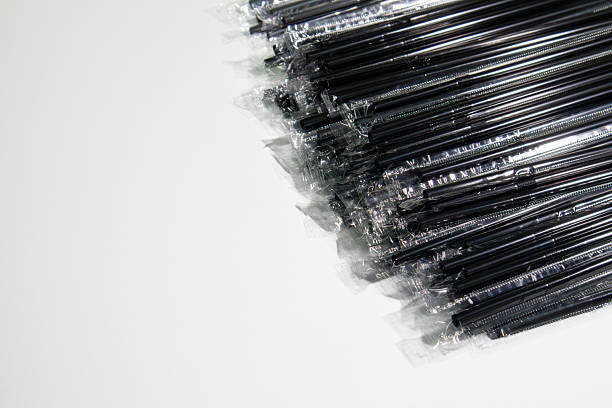 High-resolution images of black plastic straws, arranged in bulk or neatly placed. Perfect for illustrating modern takeaway culture, minimal beverage packaging design, and the environmental challenges of single-use plastics.