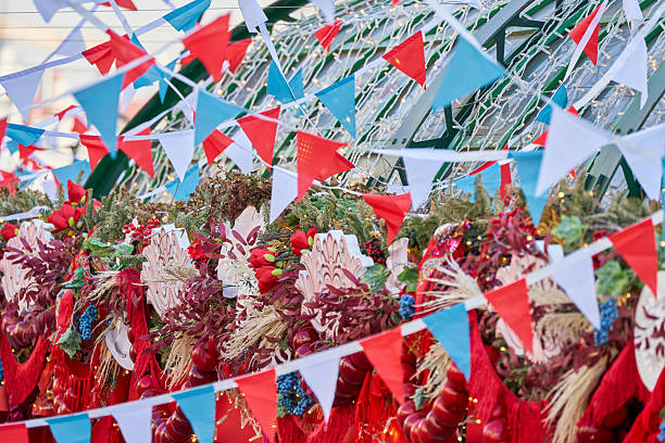 A bunch of red, white, and blue flags are hanging from a building. The flags are arranged in a way that creates a festive and celebratory atmosphere