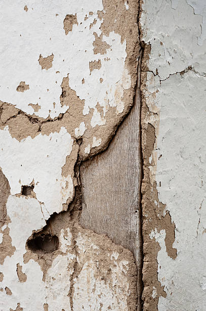 istock Old cracked clay wall. Deep cracks of a rural house 2221360762