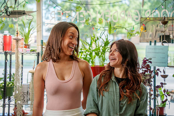 istock Friends share laugh. Indoor plant store moment. 2221360879