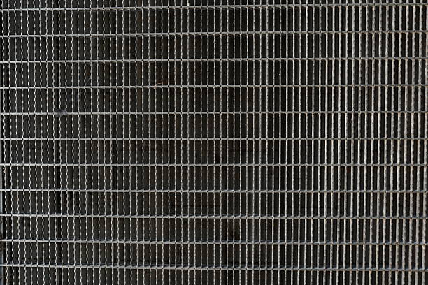 A background image of a corridor built from gray steel grating panels.
