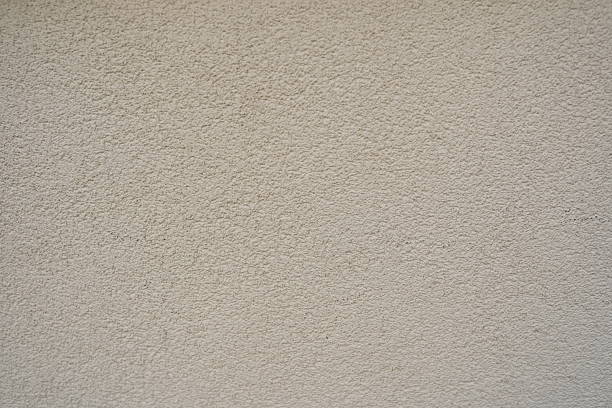 istock white mortar wall background. Stone plastered stucco wall. Color gray grunge cement backgrounds. Raw concrete texture. top view. 2221369071