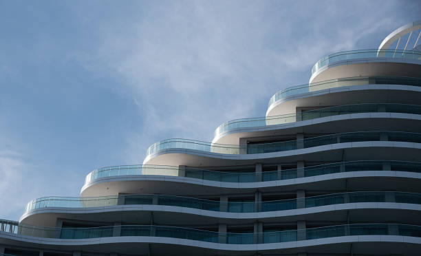 istock Modern building architecture apartments showing rounded balconies against blue sky 2221371436