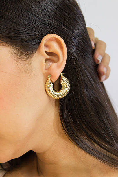 istock A golden earring in one ear 2221379107