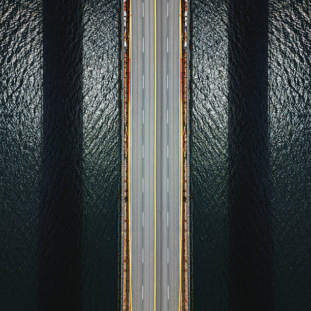 Aerial symmetrical composite photo of a suspension bridge.