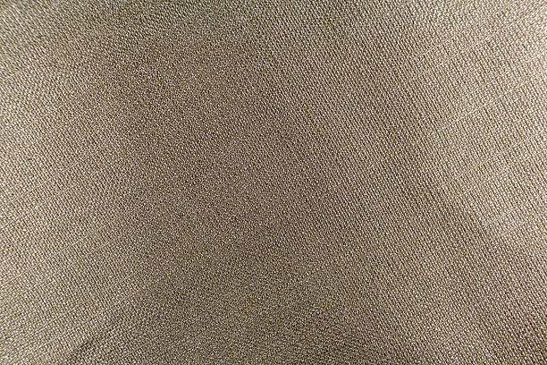 The texture of gray fabric with interweaving threads.