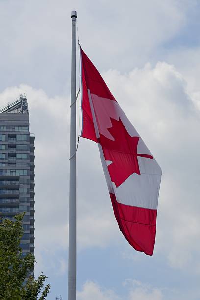 istock Canadian Flag Flying Against a Cloudy Sky 2221389965