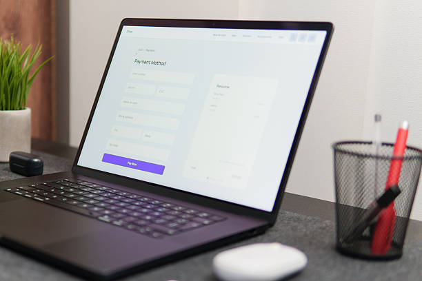 istock Laptop showing payment method form on desk in modern office 2221399003