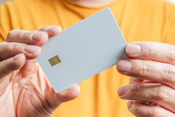istock Man holding white credit card with microchip 2221399014