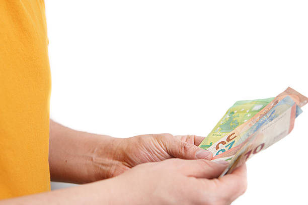 Hand holding a 1 euro coin