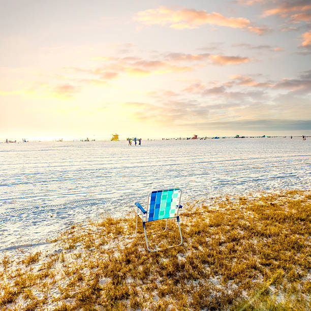 orange beach chair in the snd dunes at baltic sea at sunset