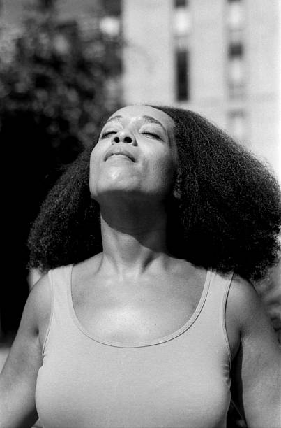istock Woman enjoying sunlight with closed eyes and head tilted back 2221418044