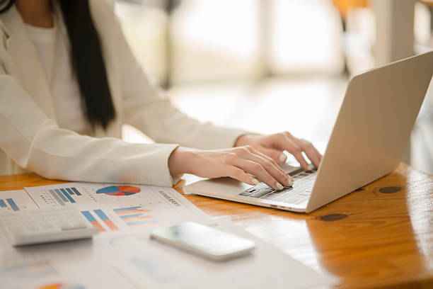 istock Businesswoman sitting working on documents, graphs placed on a desk in the office. 2221418125