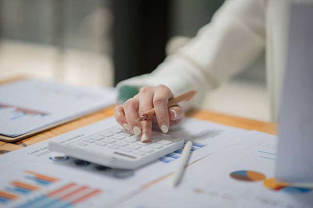 istock Businesswoman sitting working on documents, graphs placed on a desk in the office. 2221418147