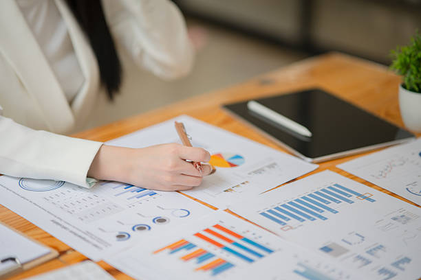 istock Businesswoman sitting working on documents, graphs placed on a desk in the office. 2221418152