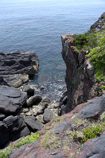 Rocky cliffs at Cape Nagasakibana, the most southern headland on the Satsuma Peninsula at the entrance to Kagoshima Bay, Kyushu, Japan.