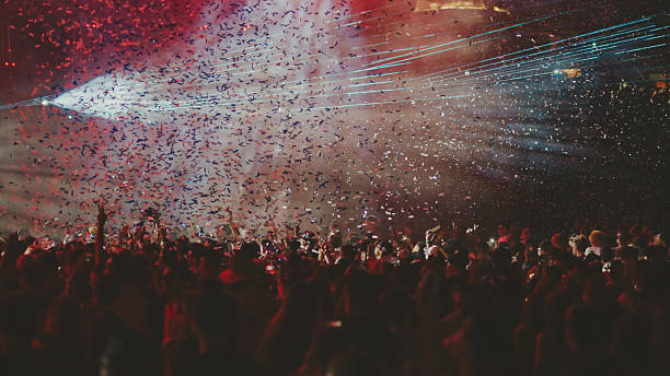 Rear view of large group of people enjoying a concert festival.