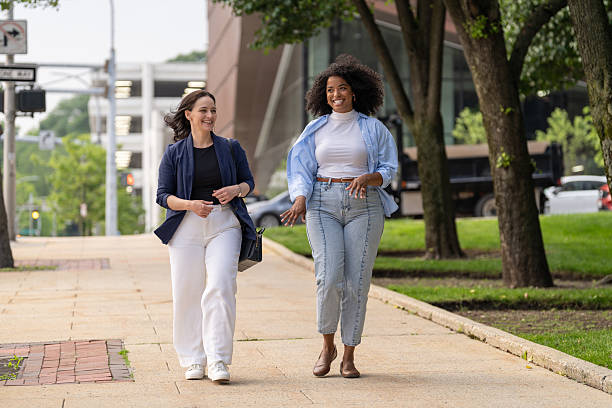 istock Two friends walking in the city 2221431940