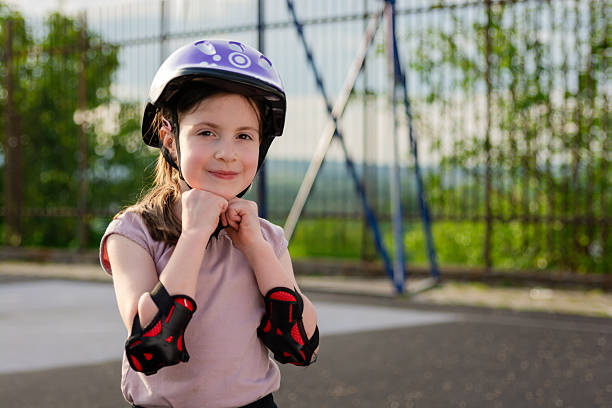 istock Happy cute girl putting cycle helmet 2221432174