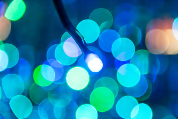 Bright blue, green, and white lights twinkle softly, creating a dreamy bokeh effect. This enchanting display adds a festive feel to the evening, inviting celebration and joy.