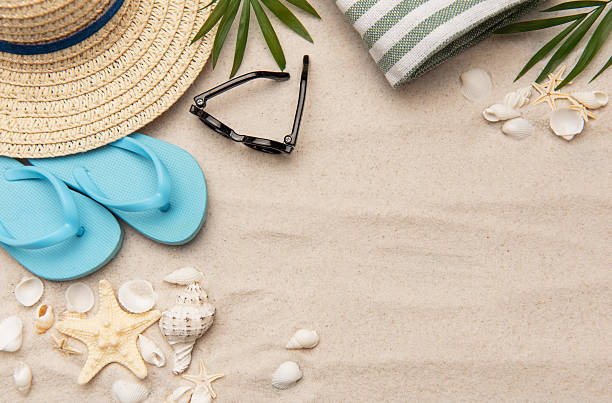 istock Beach accessories lying on sand creating summer vacation background 2221436056