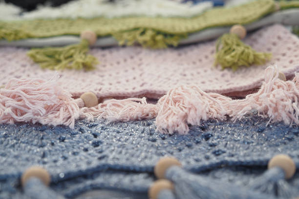 Brightly colored textiles showcase intricate designs and decorative fringes.