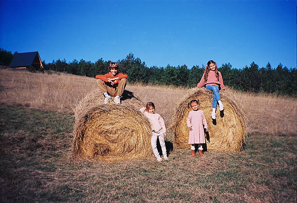 Happy kids playing in nature on sunset. It’s beautiful autumn day. Shoot by film.