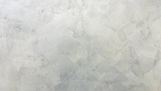istock Light gray polished concrete wall texture with uneven patterns. Ideal for use as a minimalist background, industrial design element, or architectural texture. 2221439473
